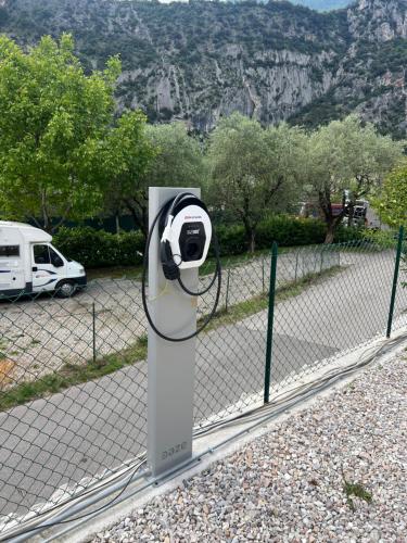 a fence with a security camera on top of it at Villa Betty Apartments in Arco
