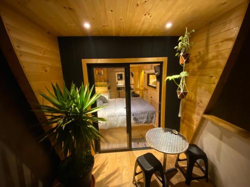 a bedroom with a bed and a table in a room at Hostal Kuyen in Pichilemu