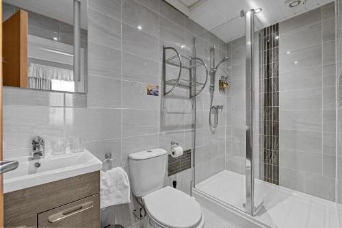 a bathroom with a shower and a toilet and a sink at Invicta Hotel Plymouth in Plymouth