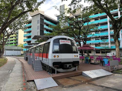 a train is parked in front of a building at Train Pod at one-north in Singapore