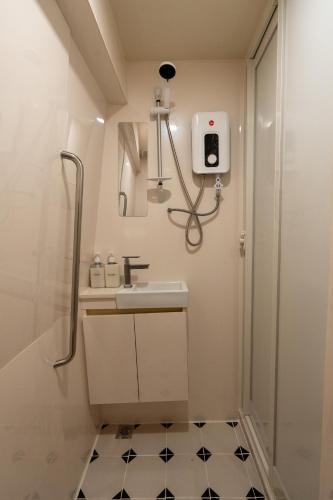 a bathroom with a sink and a shower at Train Pod at one-north in Singapore