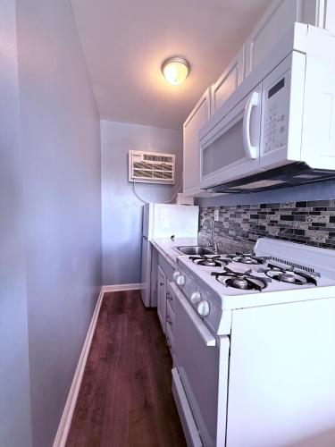 a kitchen with a white stove and white cabinets at Twilight Motel in Wildwood