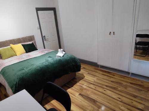 a bedroom with a bed and a table and chairs at Double-Bedroom in the Heart of Harpurhey Manchester A2 Perfect for Short Stays in Manchester