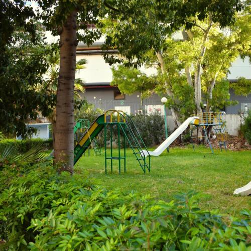 a playground with a slide in a yard at tanger in Aïn Diab