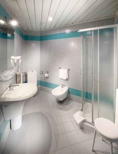 a bathroom with a sink and a toilet and a shower at Tuscany Inn in Montecatini Terme