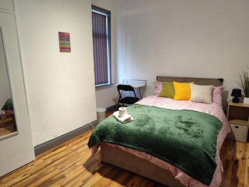 a bedroom with a bed and a chair in it at Double-Bedroom in the Heart of Harpurhey Manchester A2 Perfect for Short Stays in Manchester