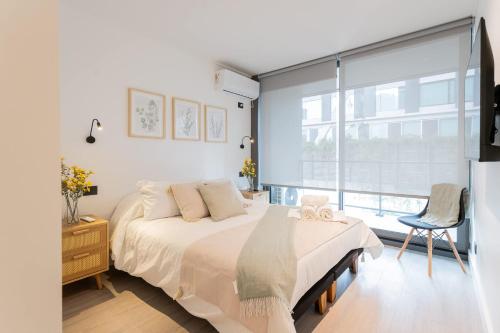 a bedroom with a bed and a large window at Luxury Living 2BR Ideal for Families in Santiago