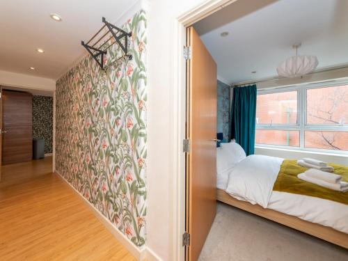 a bedroom with a bed and a large window at Pass the Keys Lovely Central Reading Flat in Reading