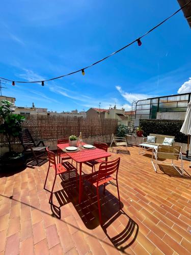 a red table and chairs on a brick patio at Exclusive Top Floor - Love Suite in Nice