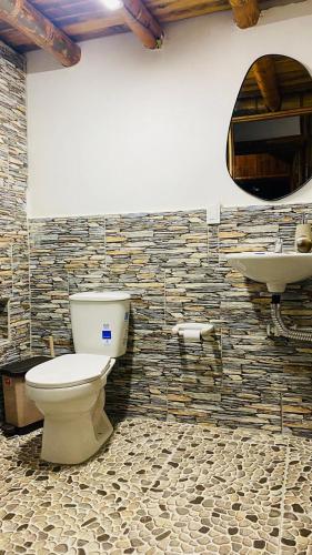 a bathroom with a toilet and a sink at Cabaña de lujo con jacuzzi Makana in San Luis