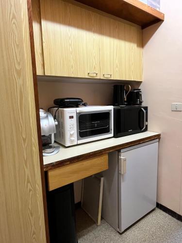 a kitchen with a microwave and a toaster oven on a counter at Studio familial, chaleureux, pied des pistes, 5e étage, côté calme in Superdevoluy
