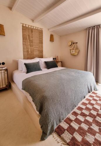 a bedroom with a large bed in a room at Nomad Hotel & Spa Altea in Altea
