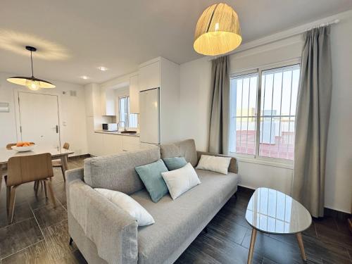 a living room with a couch and a table at Apartamentos Turísticos Santo Rostro in Chipiona