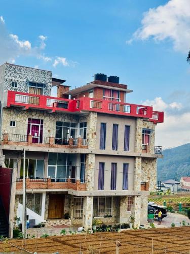 a large building with red and purple windows and a sky at Sumari Resort in Nuwara Eliya