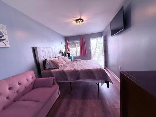 a bedroom with a bed and a couch at Twilight Motel in Wildwood