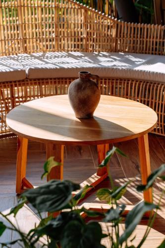 a vase sitting on top of a wooden table at Cocoon Resort Kuching in Kuching
