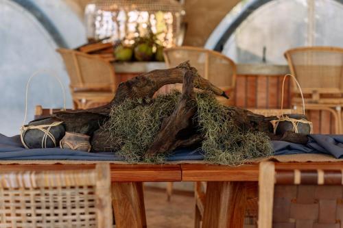 a wooden table with a pile of grass on it at Cocoon Resort Kuching in Kuching