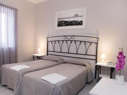 Ліжко або ліжка в номері Pietra Pomice Hotel