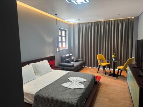 a bedroom with a bed and a living room at Villa Kristiano 21 in Sarandë