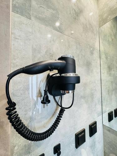 a phone hanging on a wall in a bathroom at Apartamenty BLUE BALTIC SPA Jacuzzi & Sauna MORZE in Chłopy