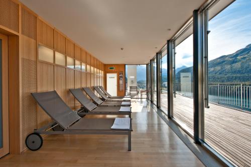 a row of chairs in a room with windows at Hotel Schweizerhof St. Moritz in St. Moritz