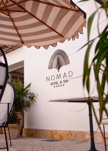 a sign for the nomad hotel and spa at Nomad Hotel & Spa Altea in Altea