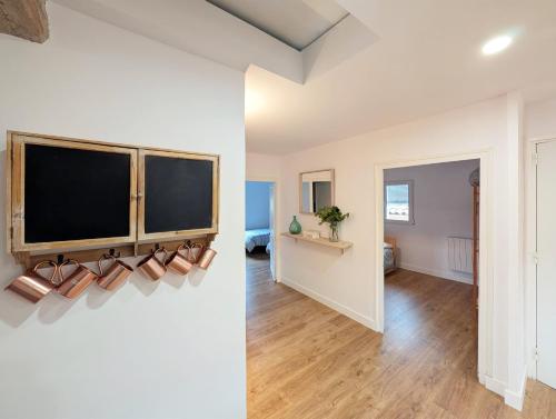 a living room with a tv on a wall at Cal Moline 2 Estel in Aviá