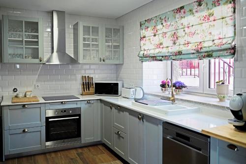 a kitchen with a sink and a stove top oven at A Casa de Sobrado - Countryside House in Barros
