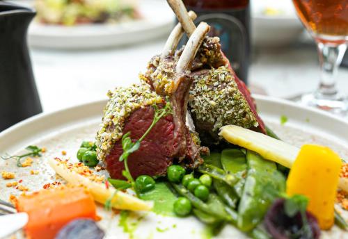 a plate of food with meat and vegetables on a table at Buitenplaats Kasteel Elsloo in Elsloo