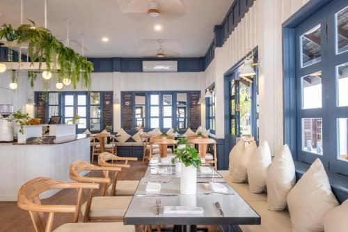 a dining room with a table and chairs at Sanctuary Hotel Luang Prabang in Luang Prabang