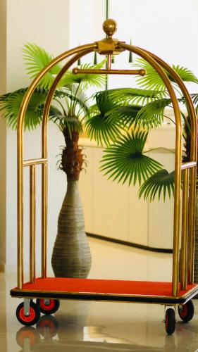 a metal rack with a vase with a plant in it at Ailana Hotel in Aqaba