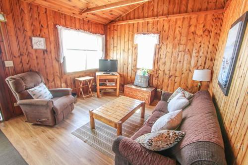 a living room with a couch and a chair at Sunnyside Combined 6BR 3BA Lakefront Retreat in Lincoln Junction