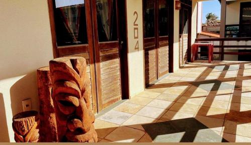 a building with a sign in front of a door at Ondas do mar Taiba Residence in Taíba