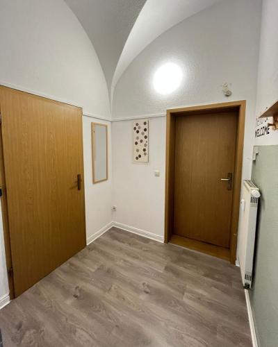 an empty room with two doors and a hallway at Direkt am Freizeitpark Plohn by Immo Franzi in Lengenfeld