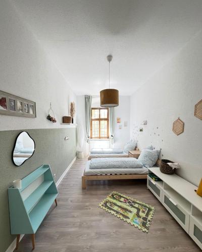a white room with two beds and a couch at Direkt am Freizeitpark Plohn by Immo Franzi in Lengenfeld