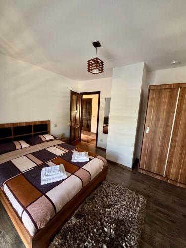 a bedroom with a large bed with towels on it at Casa Ioana Moisei in Moisei