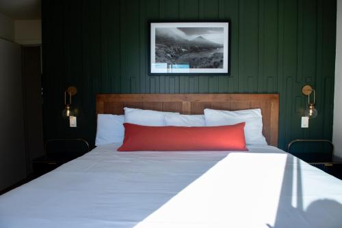 a bedroom with a bed with a red pillow at Bodega Coast Inn and Suites in Bodega Bay