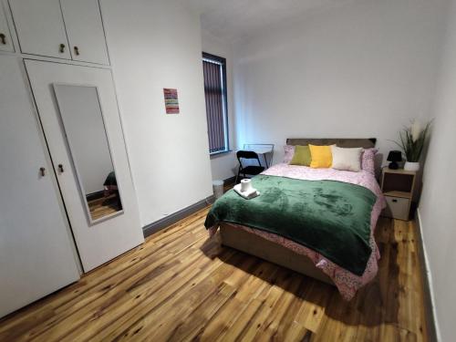 a bedroom with a bed and a dresser and a mirror at Double-Bedroom in the Heart of Harpurhey Manchester A3 Perfect for Short Stays in Manchester