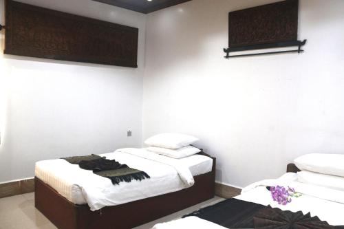 Ένα ή περισσότερα κρεβάτια σε δωμάτιο στο Shining Angkor Apartment Hotel