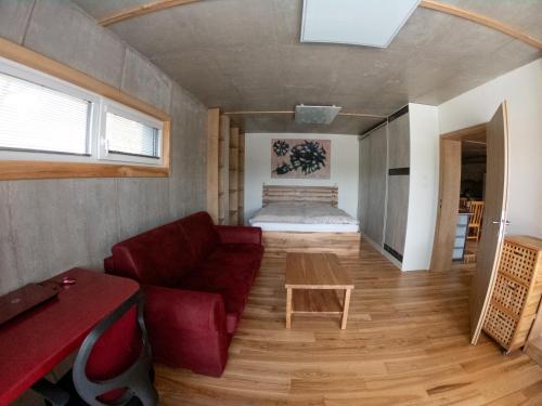 a living room with a couch and a bed at Apartmán U Holoubka in Nové Město na Moravě