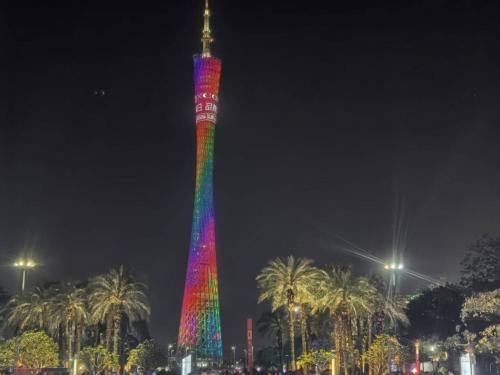 a tall tower is lit up with a rainbow at Guangzhou Yashe Hotel - Keyun Road Metro Station Pazhou Convention and Exhibition Store in Guangzhou