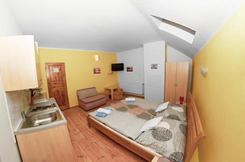 a small room with a bed and a sink at Vila Rhea in Važec