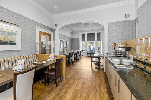 a restaurant with a dining room with tables and chairs at Invicta Hotel Plymouth in Plymouth