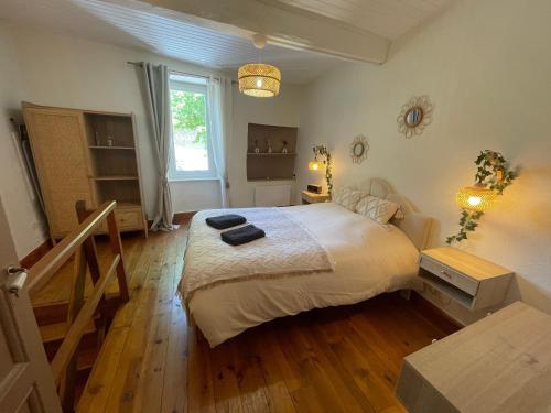 a bedroom with a large bed and a wooden floor at La Bohème - Cosy, calme & confort in Saint-Papoul