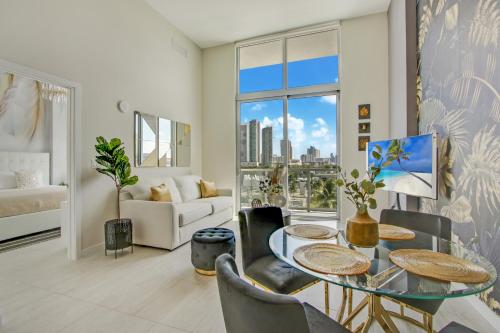 a living room with a glass table and chairs at Nomada Destination Residences - Quadro in Miami