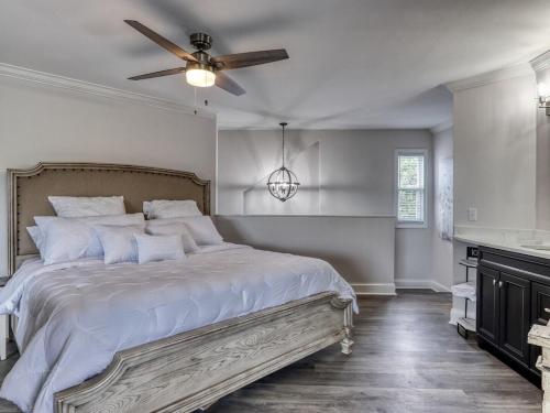 a bedroom with a bed with a ceiling fan at Tranquility Skies by Avada Properties in Gatlinburg