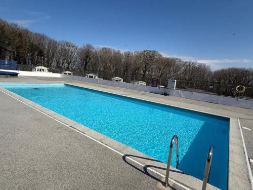 a large blue swimming pool on top of a building at Cornwall Caravan Retreat 3 Crantock in Crantock