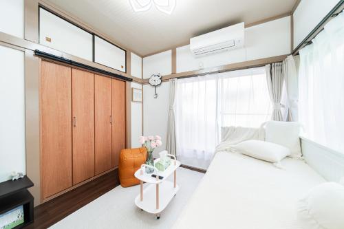 Giường trong phòng chung tại 鎌倉四丁目