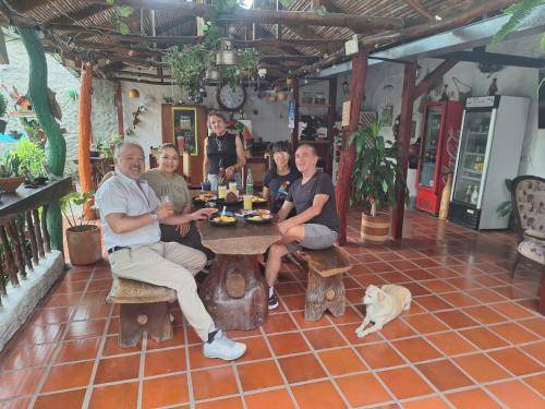 a group of people sitting at a table in a restaurant at La Liliana Hostal - Gastrobar in Jagua
