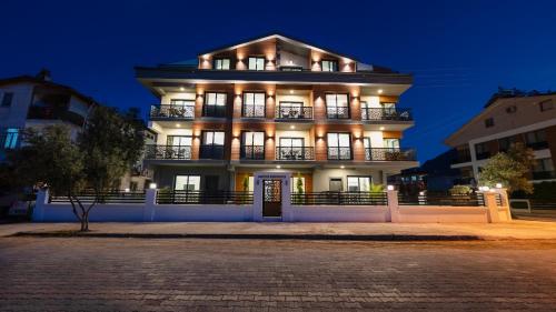 a large building at night with lights on at Mucize Residence in Fethiye